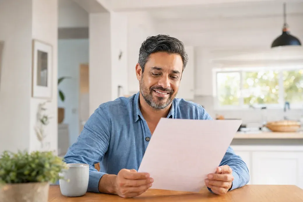 Homeowner happily reviewing his cash offer